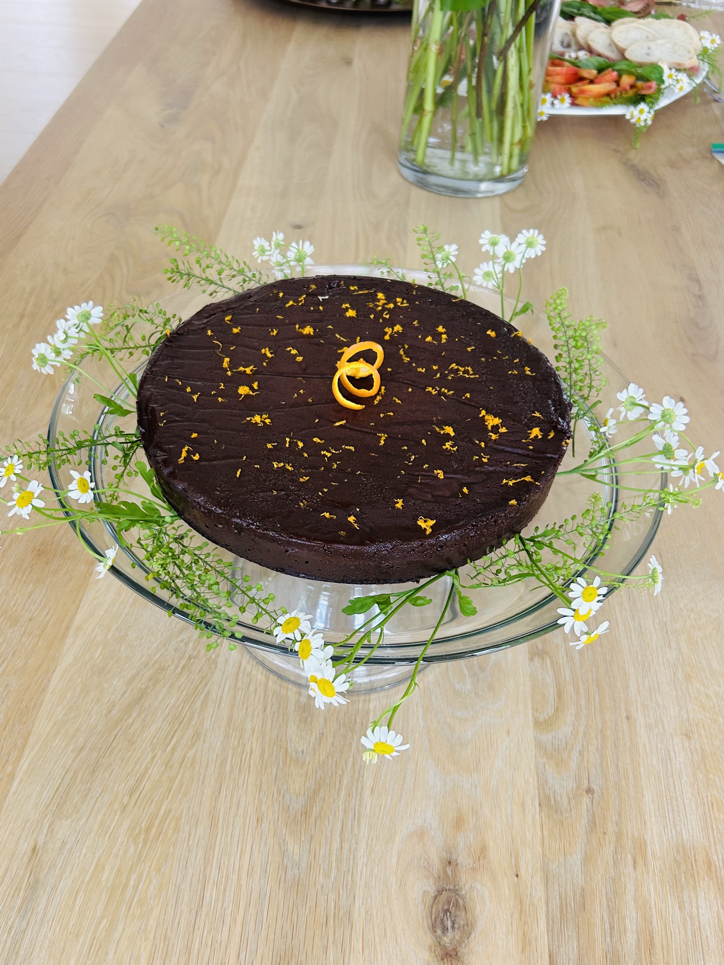 Chocolate cake with orange zest and fresh flowers