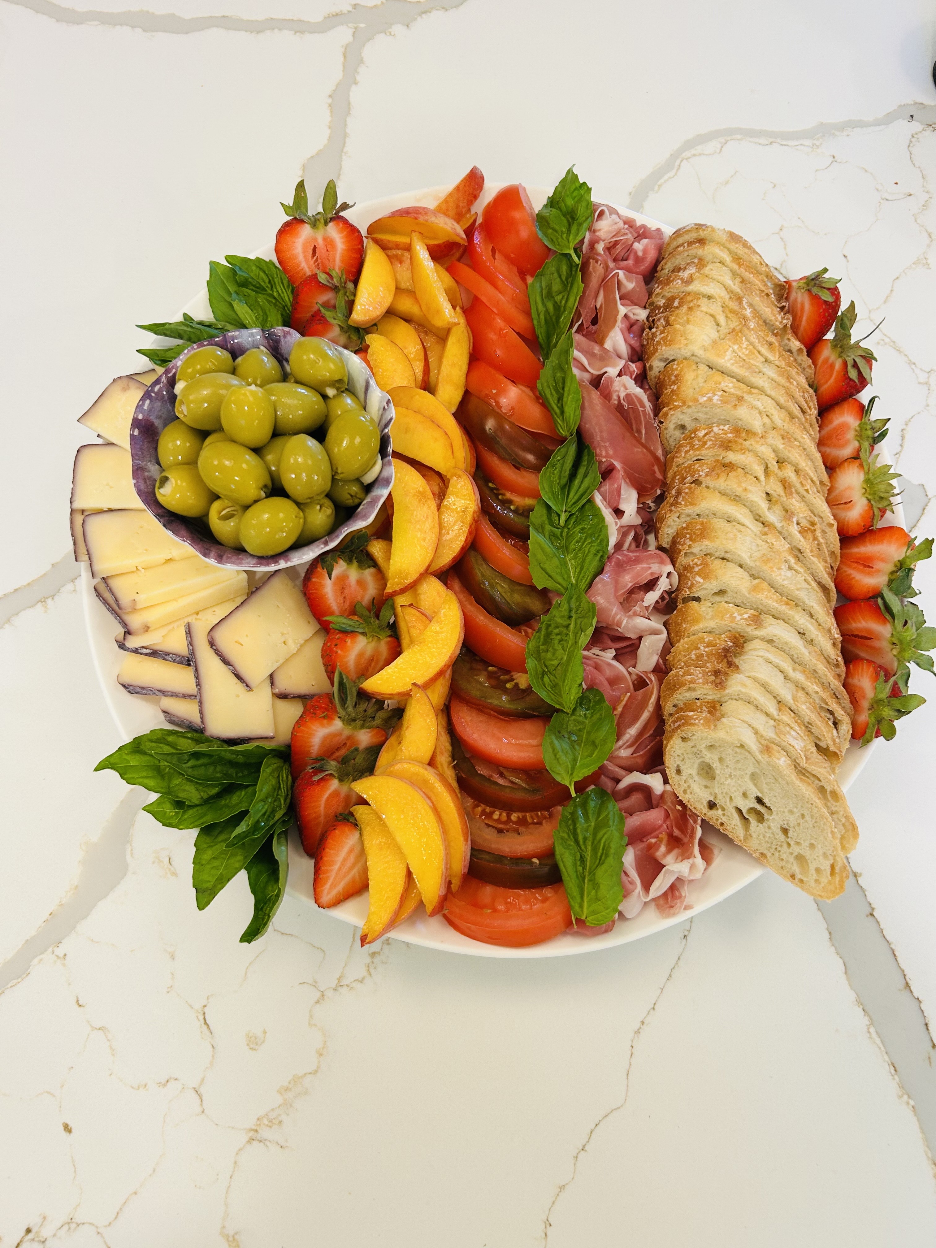 Elegant platter with prosciutto, cheese, and fresh vegetables