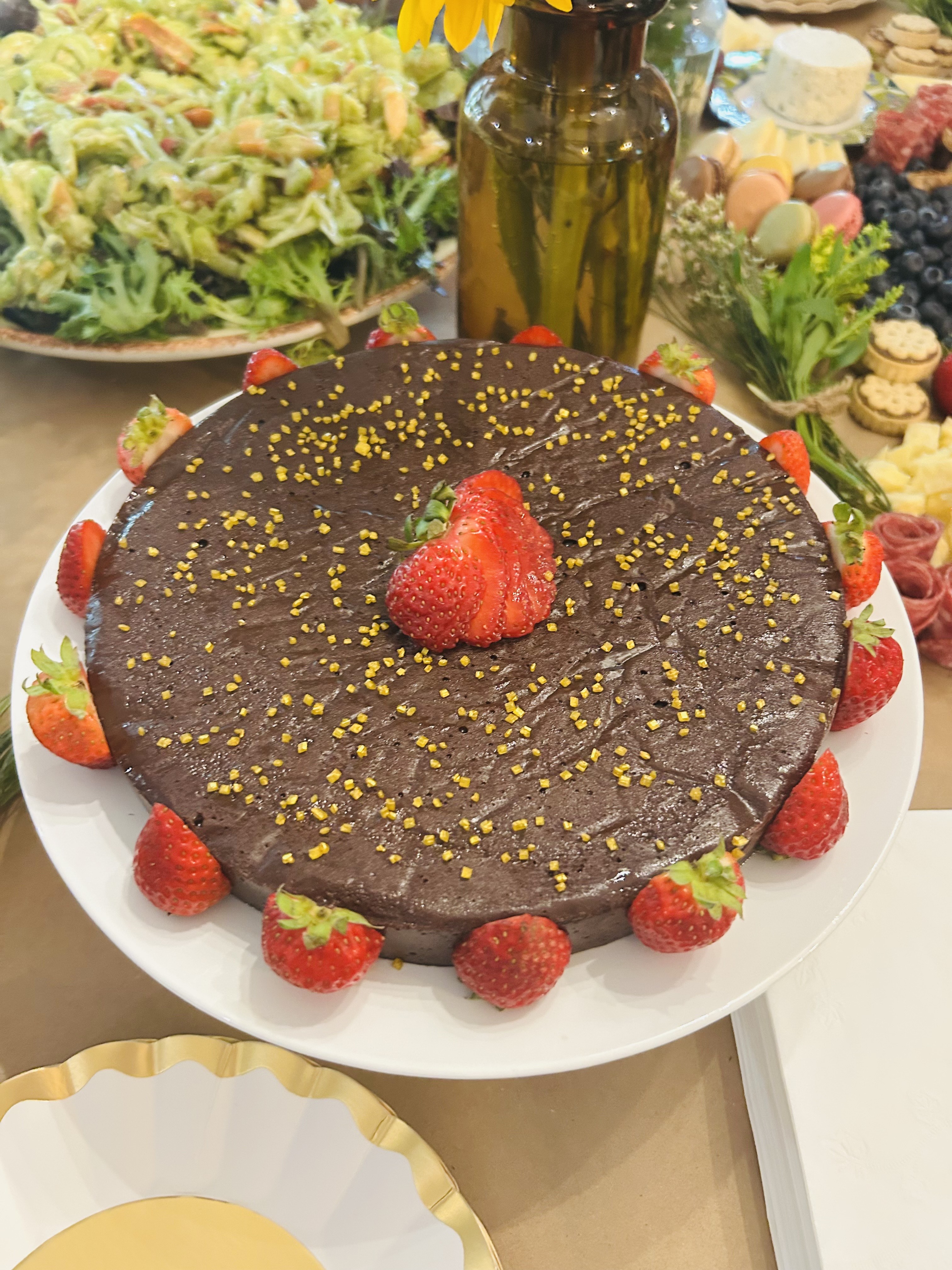 Flourless chocolate cake with strawberries and gold sprinkles