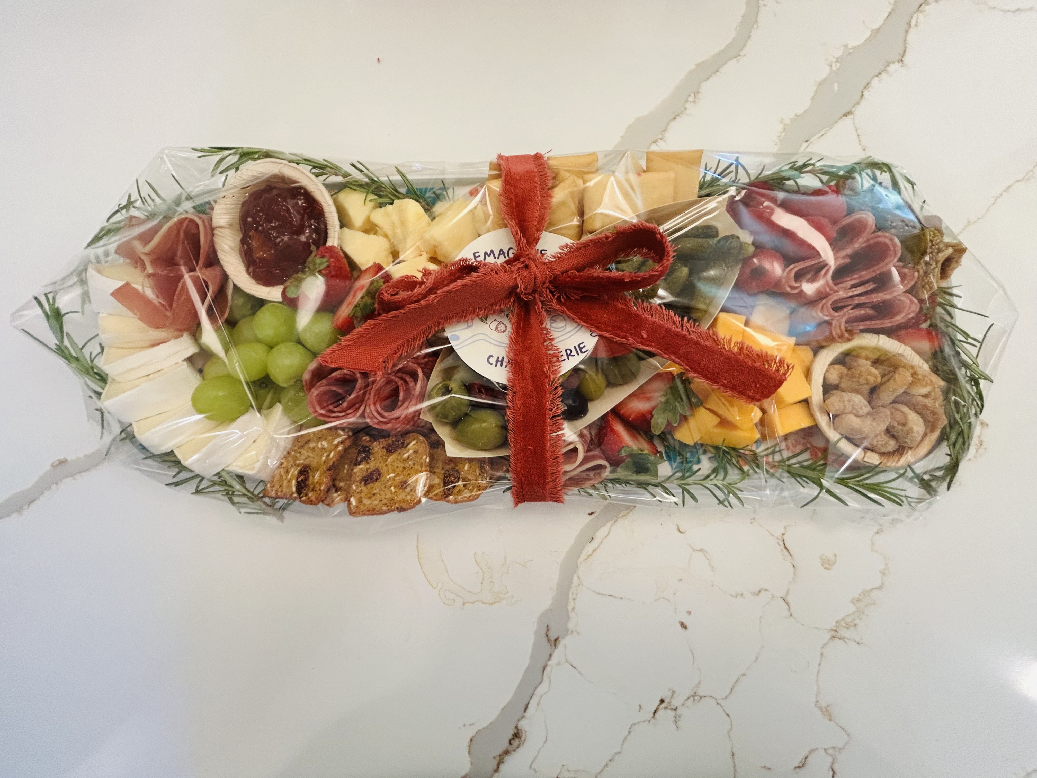 Wrapped charcuterie gift box with Emagene's label